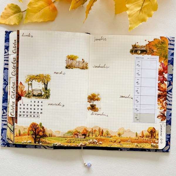 Bullet journal hebdomadaire d'octobre décoré avec des stickers PET feuilles d'érable et des illustrations de paysages d'automne.